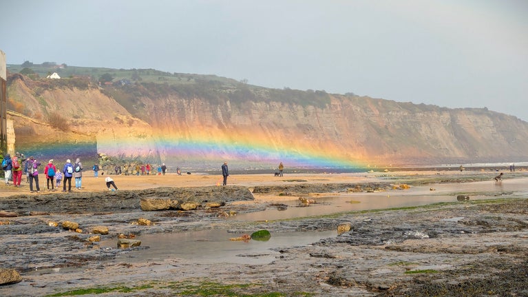 A rainbow across the beach at Robin Hood's Bay